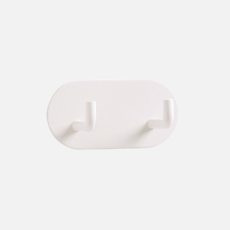 Gancho de pared Zintra – Hierro forjado pastel con tira adhesiva 3M, sin taladrar