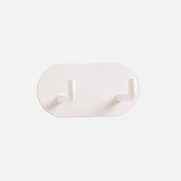 Gancho de pared Zintra – Hierro forjado pastel con tira adhesiva 3M, sin taladrar